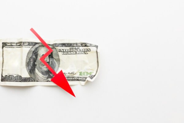 U.S. dollar bill with a red downward arrow symbolizing a sharp decline in financial penalties, revenue, or economic value.