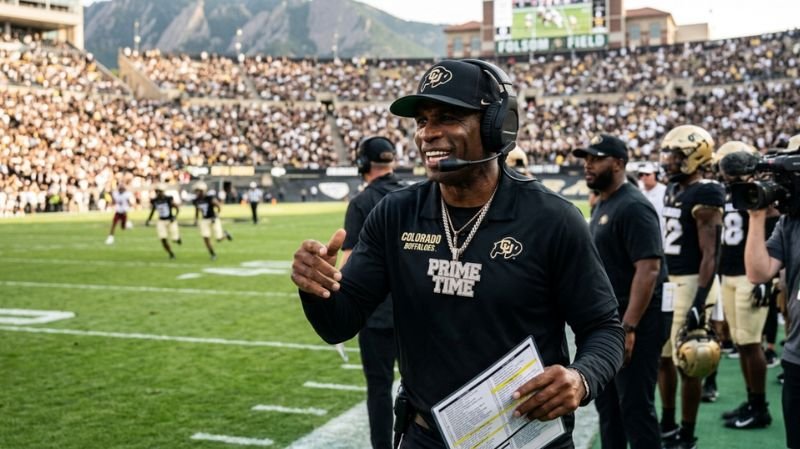 "Deion Sanders" Sanders, wearing a black headset, CU cap, and a "PRIME TIME" diamond necklace