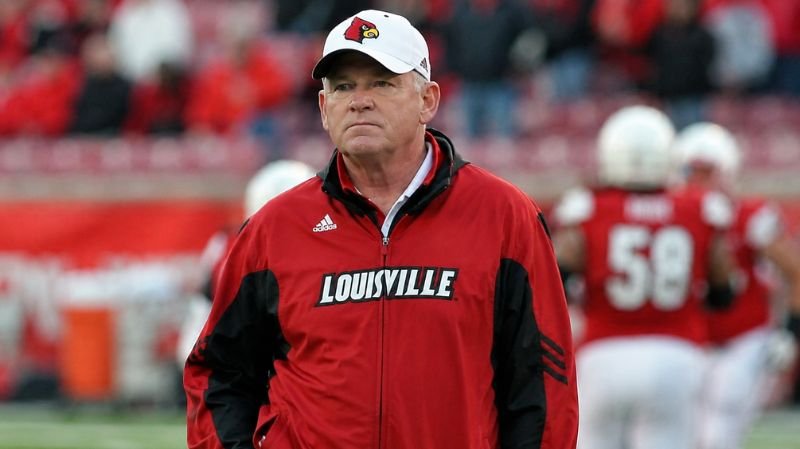 Bobby Petrino standing on the football sideline during his coaching return after the Arkansas scandal.