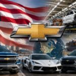 Chevrolet vehicles including a Silverado truck, Corvette, and SUV displayed in front of an American flag, auto factory assembly line, and global shipping scene.