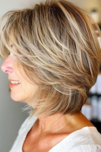 Side view of a woman over 60 with fine hair styled in a layered bob haircut adding volume and soft texture