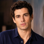Josh Grisetti posing in a professional studio portrait with a cinematic background and soft lighting.